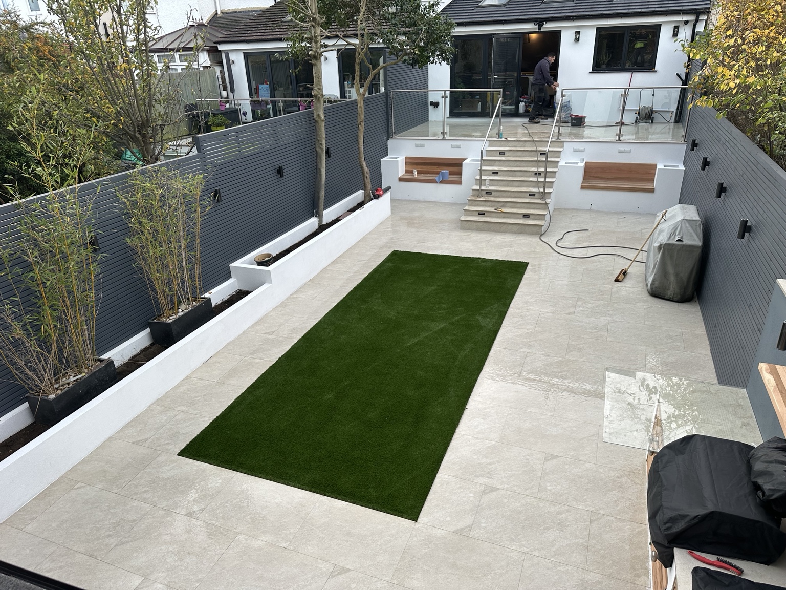 Porcelain patio and central green lawn